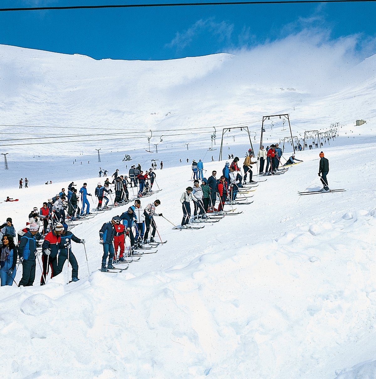 A group of tourists preparing for skiing in Morocco Oukaimeden on the snowy slopes of the High Atlas with Yassmine Trip.