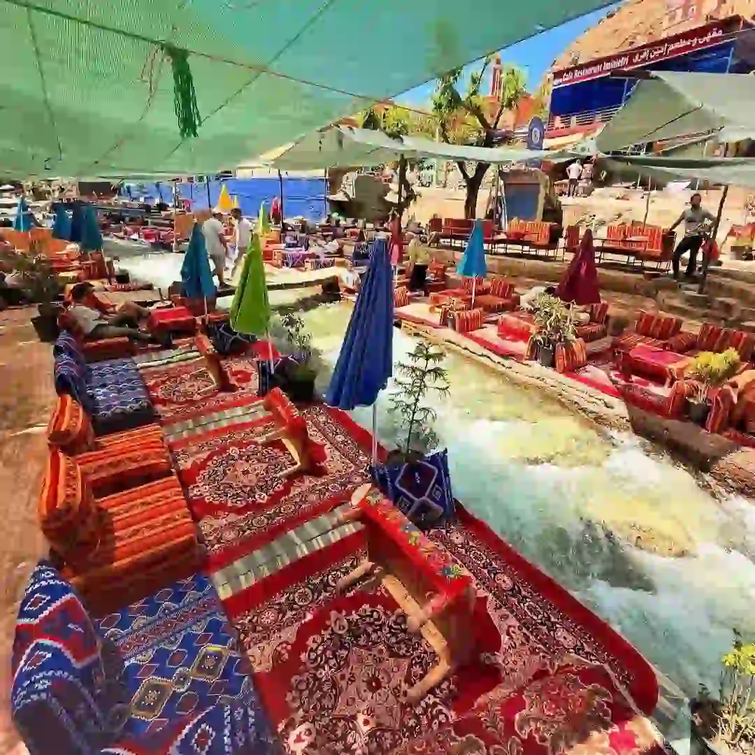 Traditional riverside restaurants and waterfalls during an Ourika Valley day trip from Marrakech.